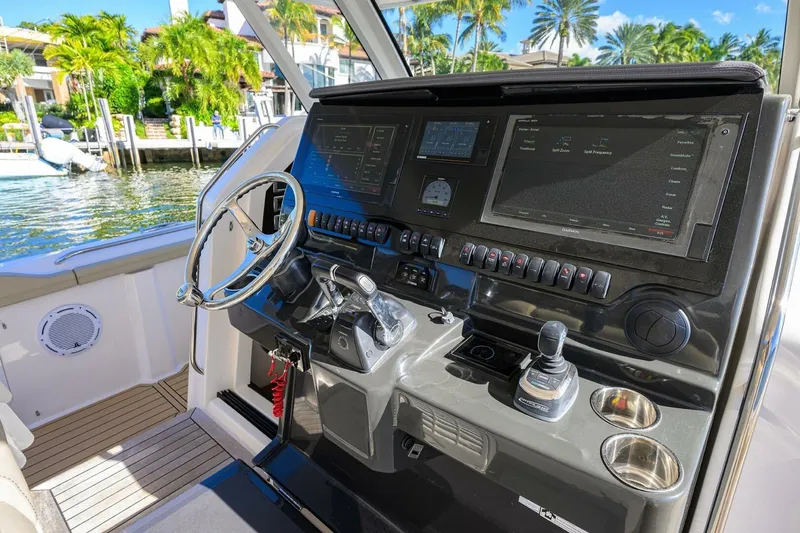 Slide: The Image of 2018 Pursuit S 408 Sport boat dashboard with advanced navigation controls and displays. - 11