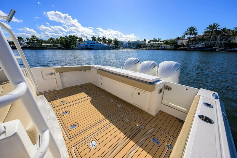 Slide: The Image of 2018 Pursuit S 408 Sport boat deck with scenic waterfront view. - 20
