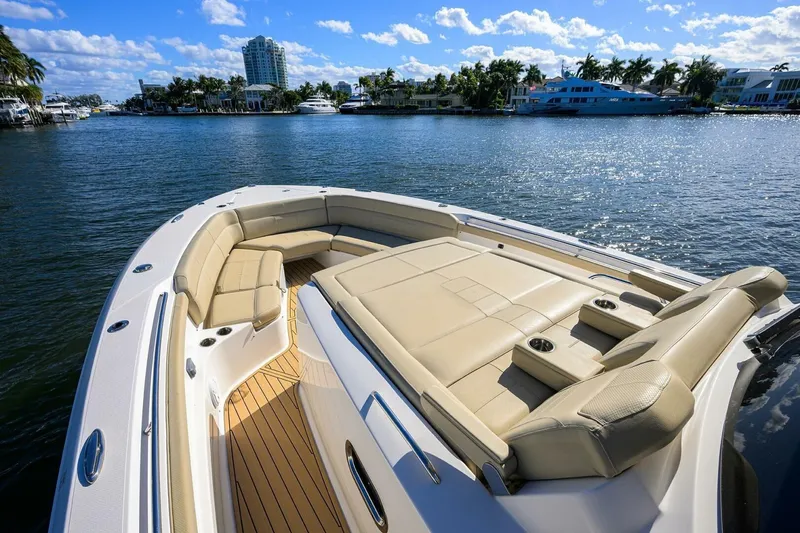 Slide: The Image of Luxurious 2018 Pursuit S 408 Sport boat with spacious seating on a sunny waterfront. - 33
