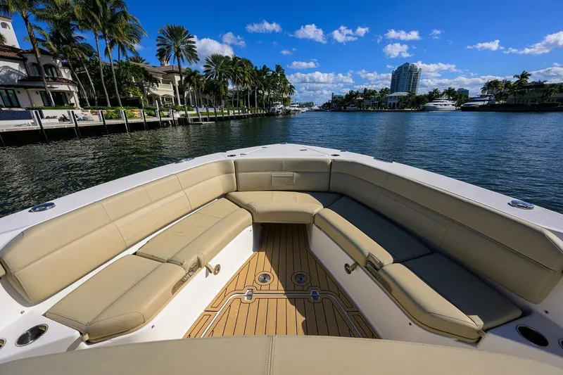 Slide: The Image of 2018 Pursuit S 408 Sport boat with spacious seating, cruising on a scenic waterway. - 35