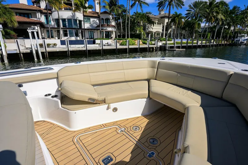 Slide: The Image of Luxurious 2018 Pursuit S 408 Sport boat interior with beige seating and waterfront view. - 36
