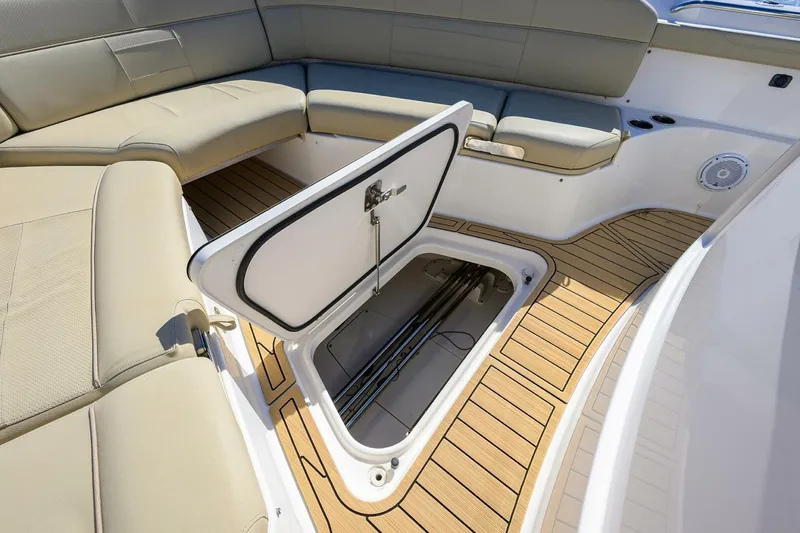 Slide: The Image of 2018 Pursuit S 408 Sport boat interior with open storage compartment and cushioned seating. - 39