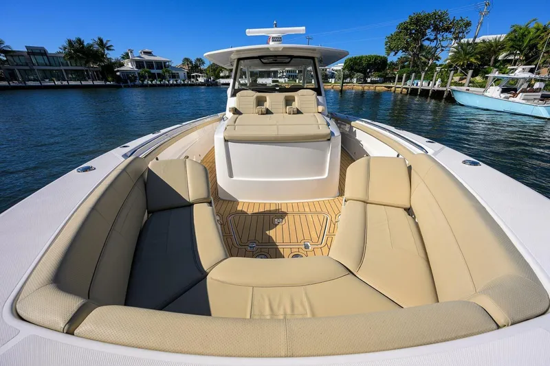 Slide: The Image of 2018 Pursuit S 408 Sport boat with spacious seating on a sunny waterfront. - 4