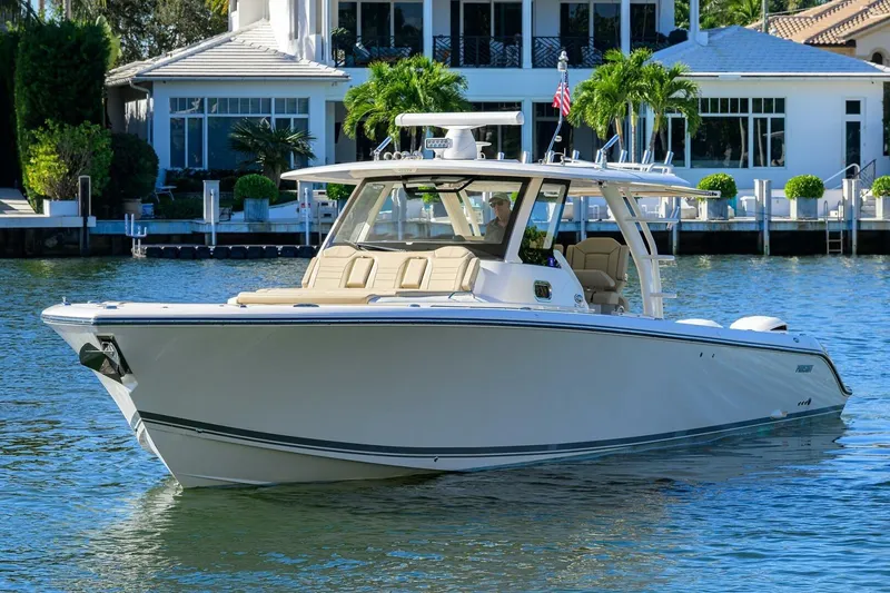 Slide: The Image of 2018 Pursuit S 408 Sport boat on water near luxury waterfront home. - 48
