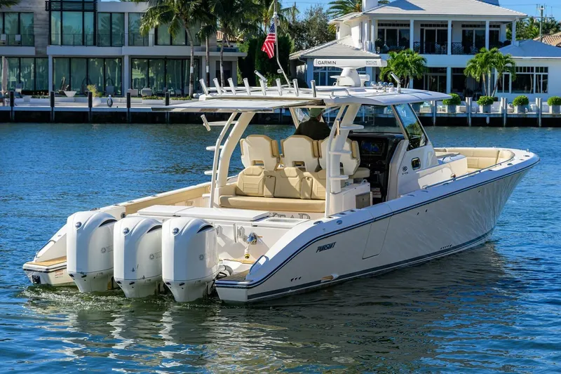 Slide: The Image of 2018 Pursuit S 408 Sport boat cruising on a sunny waterfront. - 51