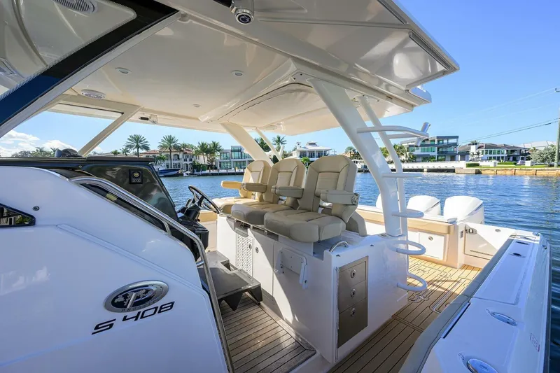 Slide: The Image of 2018 Pursuit S 408 Sport boat interior with luxurious seating and waterfront view. - 8