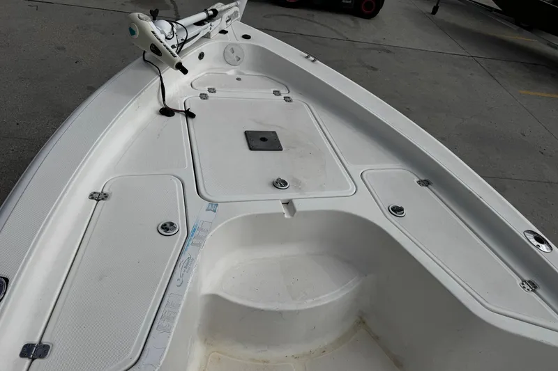 Slide: The Image of 2005 Sea Fox 205 Bay Fisher boat deck with storage compartments and trolling motor. - 14