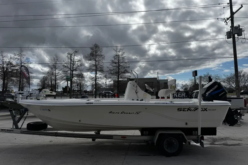 Slide: The Image of 2005 Sea Fox 205 Bay Fisher boat on trailer under cloudy sky. - 5
