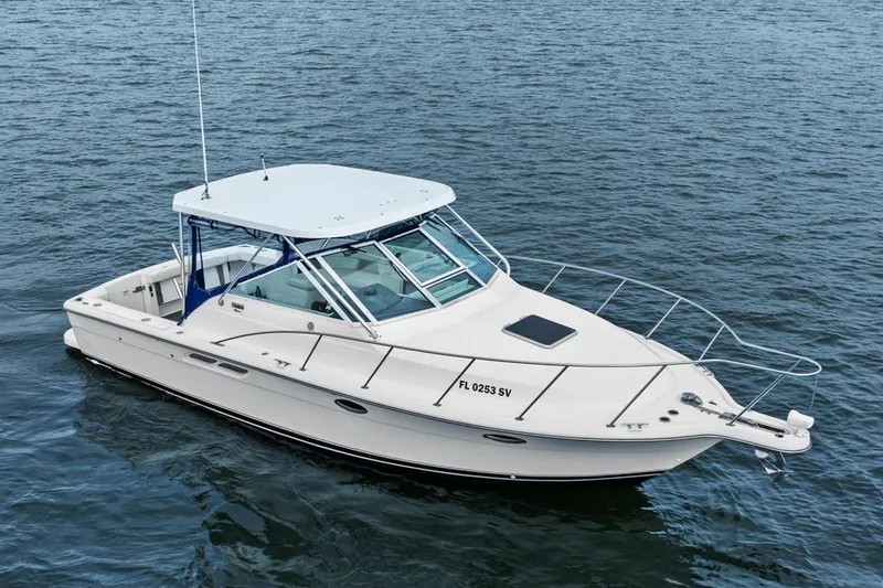 The Image of 2005 Tiara Open Classic boat on calm water, featuring sleek design and white exterior. - 0