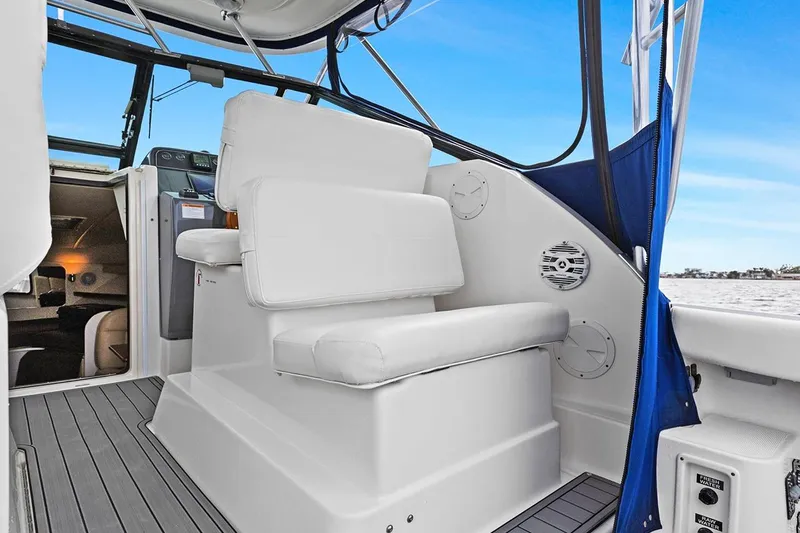 Slide: The Image of 2005 Tiara Open Classic boat interior with white seating and blue accents. - 11