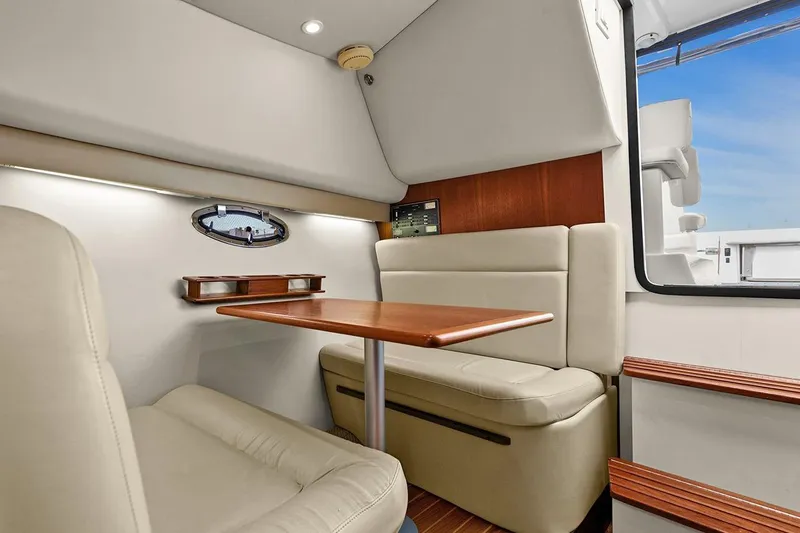 Slide: The Image of 2005 Tiara Open Classic yacht interior with beige seating and wooden table. - 17