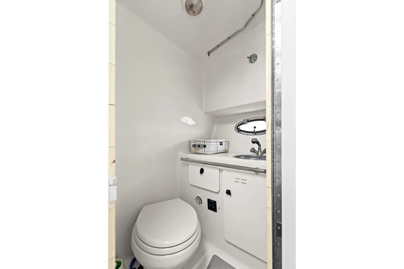 Slide: The Image of Compact bathroom in 2005 Tiara Open Classic boat, featuring toilet and sink. - 20