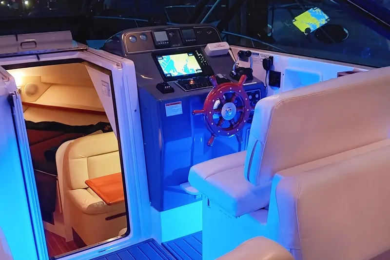 Slide: The Image of 2005 Tiara Open Classic boat interior with illuminated cockpit and cozy cabin. - 21