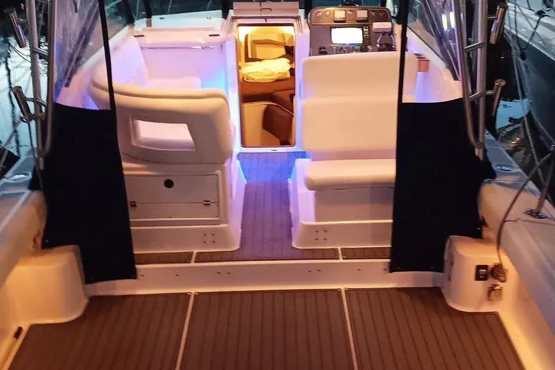 Slide: The Image of Interior view of a 2005 Tiara Open Classic boat with illuminated seating area. - 22
