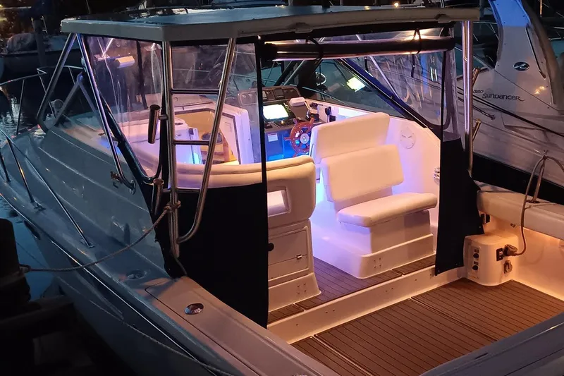 Slide: The Image of 2005 Tiara Open Classic boat with illuminated interior at a marina. - 23