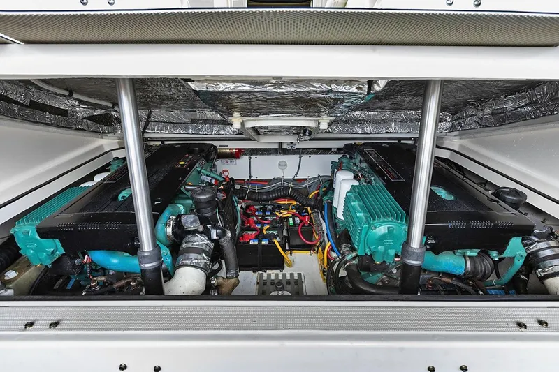 Slide: The Image of Engine compartment of a 2005 Tiara Open Classic boat, showcasing dual engines and wiring. - 24