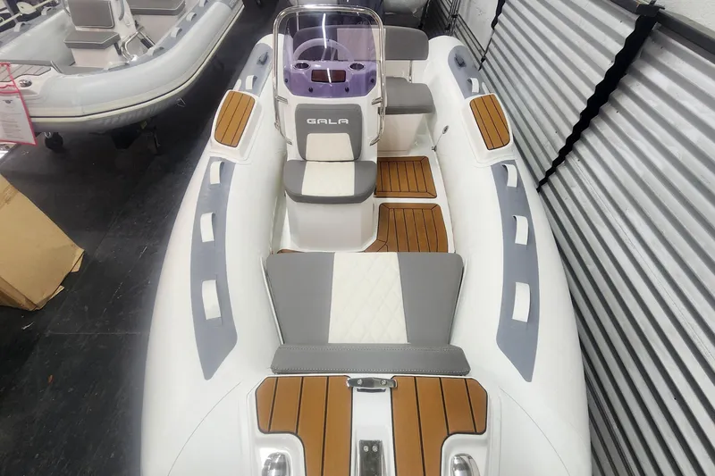 Slide: The Image of 2024 Gala A360L inflatable boat with wood accents and modern seating design. - 6