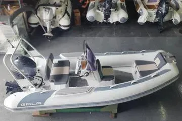 Slide: The Image of 2024 Gala A360HL boat with Tohatsu 40HP engine, displayed in a showroom. - 8