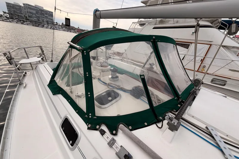 Slide: The Image of 1997 Beneteau Oceanis 351 sailboat with green canopy docked at marina. - 18