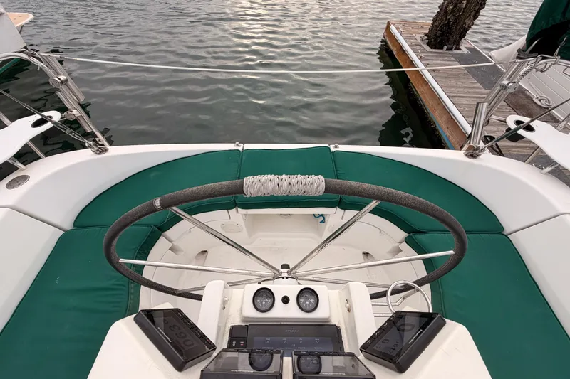 Slide: The Image of Cockpit view of 1997 Beneteau Oceanis 351 sailboat with green seating and steering wheel. - 21