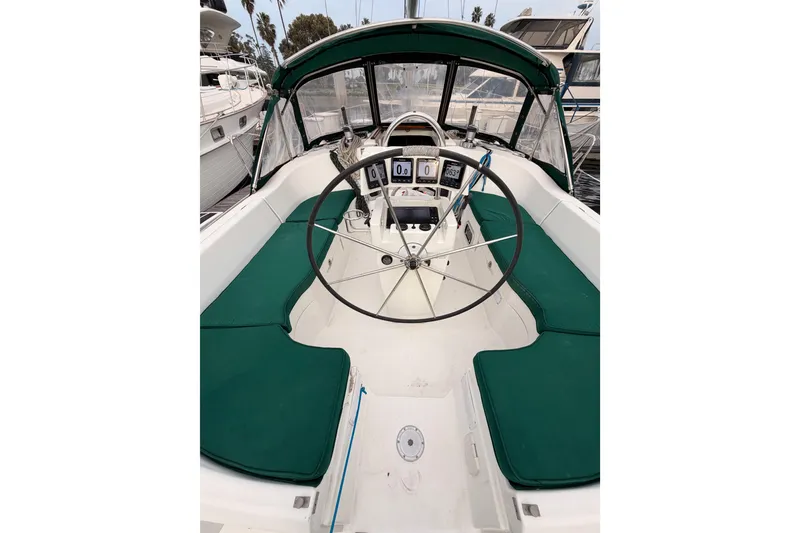 Slide: The Image of Cockpit of 1997 Beneteau Oceanis 351 sailboat with green seating and steering wheel. - 24