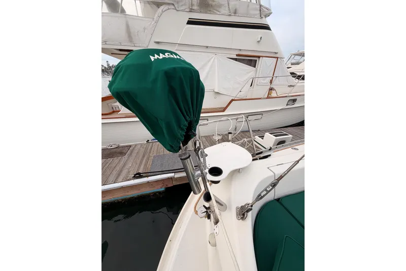 Slide: The Image of 1997 Beneteau Oceanis 351 sailboat with green cover and docked in marina. - 25