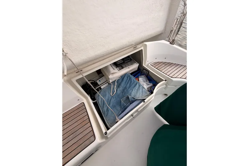 Slide: The Image of Storage compartment on a 1997 Beneteau Oceanis 351 sailboat, featuring various items and equipment. - 27