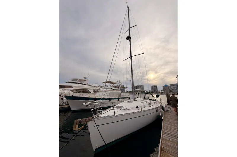 Slide: The Image of 1997 Beneteau Oceanis 351 sailboat docked at marina under cloudy sky. - 3