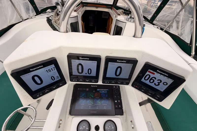 Slide: The Image of Cockpit of 1997 Beneteau Oceanis 351 with Raymarine navigation displays and steering wheel. - 30