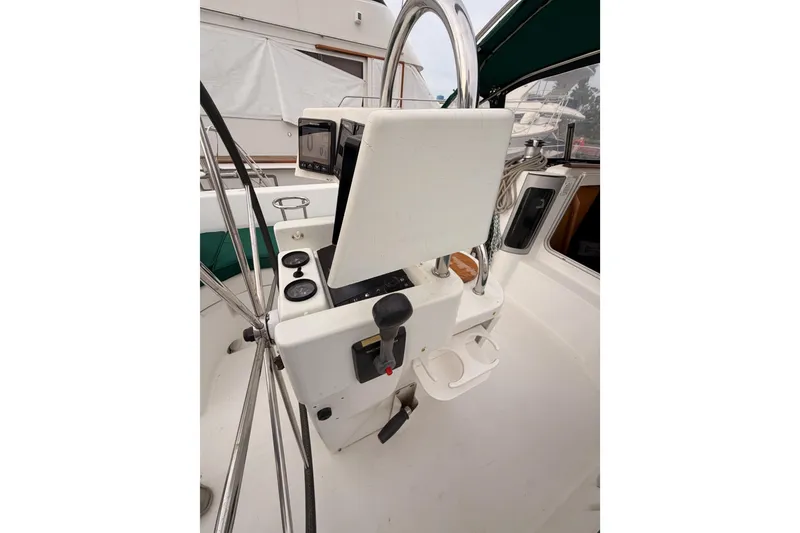 Slide: The Image of Cockpit view of 1997 Beneteau Oceanis 351 sailboat with steering wheel and navigation instruments. - 32