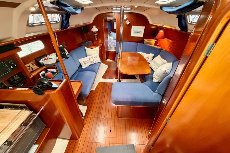 Slide: The Image of Interior of 1997 Beneteau Oceanis 351 sailboat with cozy seating and wooden finishes. - 34