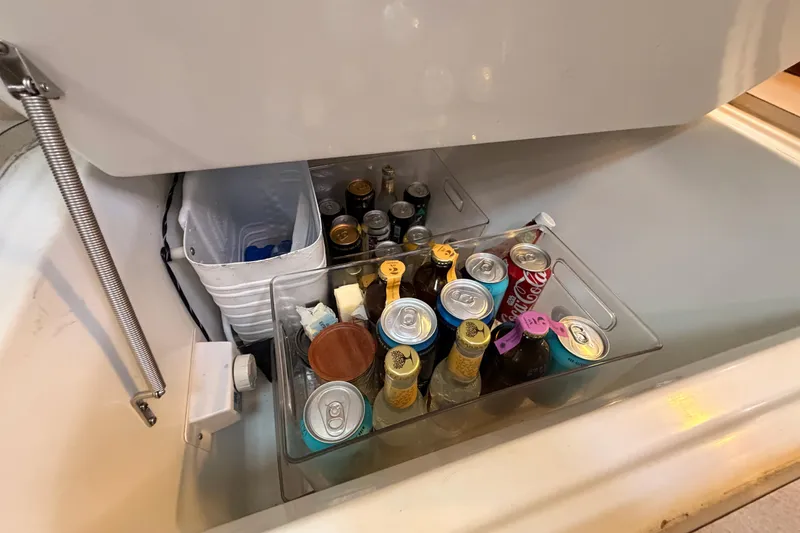 Slide: The Image of Beverage storage in 1997 Beneteau Oceanis 351 yacht, featuring assorted drinks and organized compartments. - 37