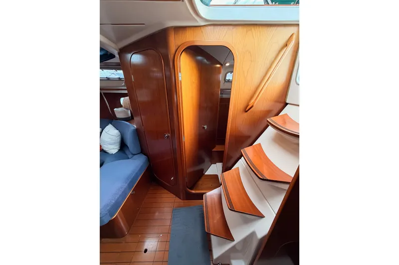 Slide: The Image of Interior of 1997 Beneteau Oceanis 351 sailboat with wooden stairs and seating area. - 39