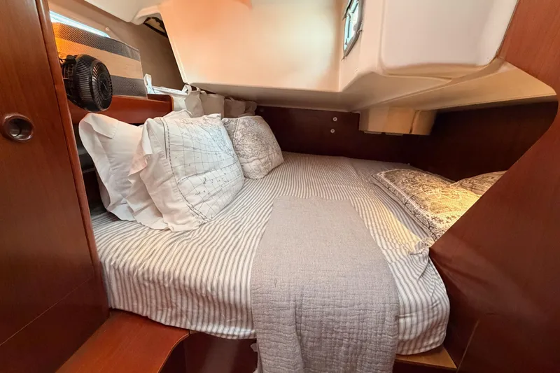 Slide: The Image of Cozy cabin interior of 1997 Beneteau Oceanis 351 sailboat with striped bedding. - 41