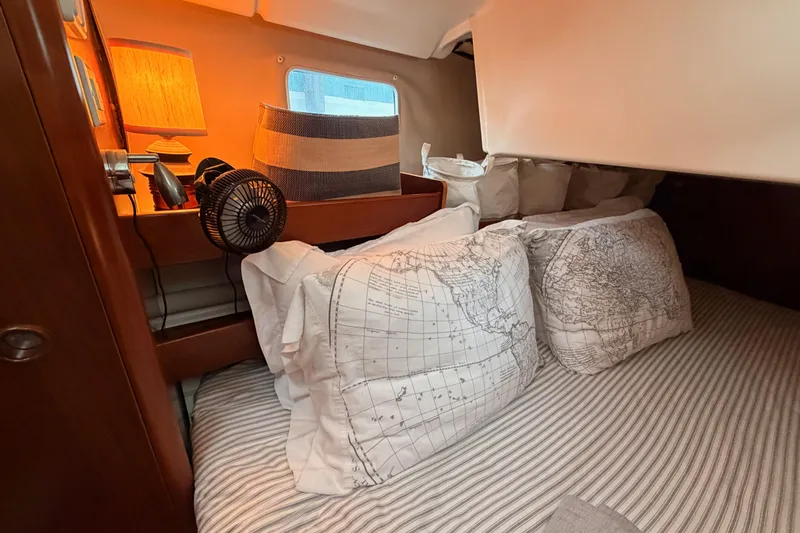 Slide: The Image of Cozy cabin interior of 1997 Beneteau Oceanis 351 with nautical-themed bedding. - 43