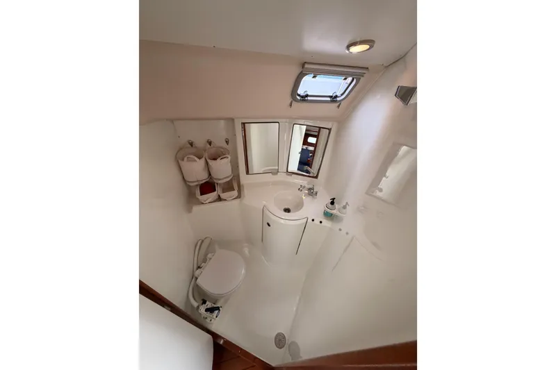 Slide: The Image of Bathroom interior of 1997 Beneteau Oceanis 351 sailboat, featuring sink, toilet, and storage. - 45