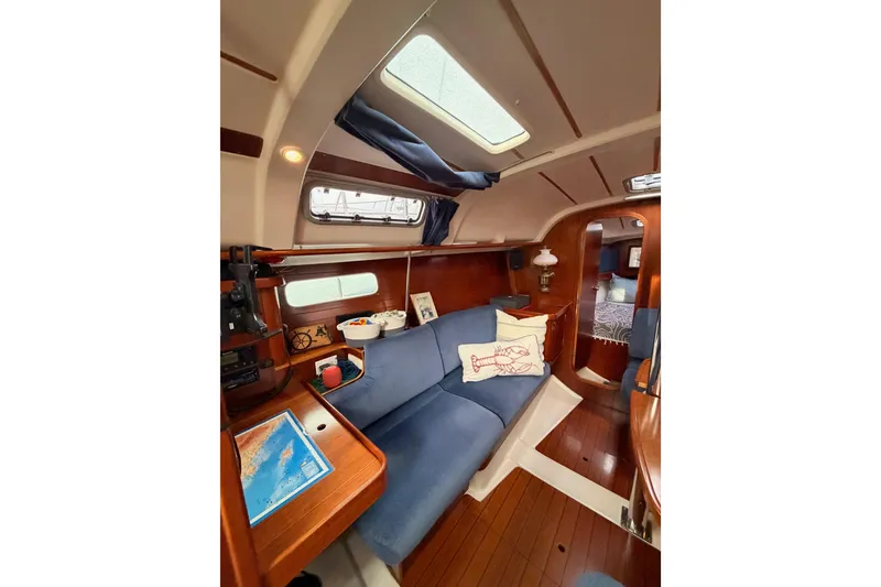Slide: The Image of Interior of 1997 Beneteau Oceanis 351 sailboat with cozy seating and nautical decor. - 49