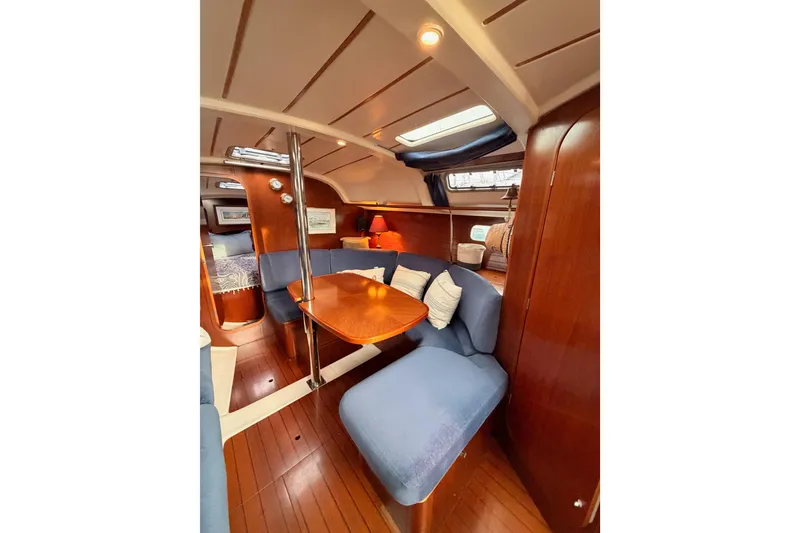 Slide: The Image of Interior of 1997 Beneteau Oceanis 351 sailboat with cozy seating and wooden finishes. - 50