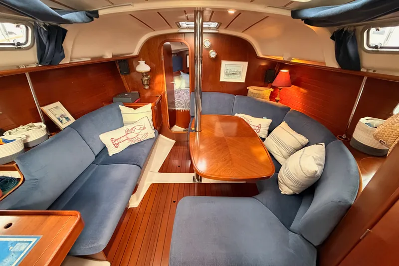 Slide: The Image of Interior of 1997 Beneteau Oceanis 351 sailboat with cozy seating and wooden table. - 51