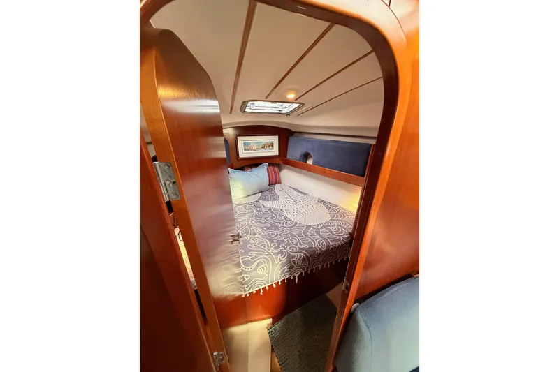 Slide: The Image of Cozy cabin interior of 1997 Beneteau Oceanis 351 sailboat with wood finish and bedding. - 54