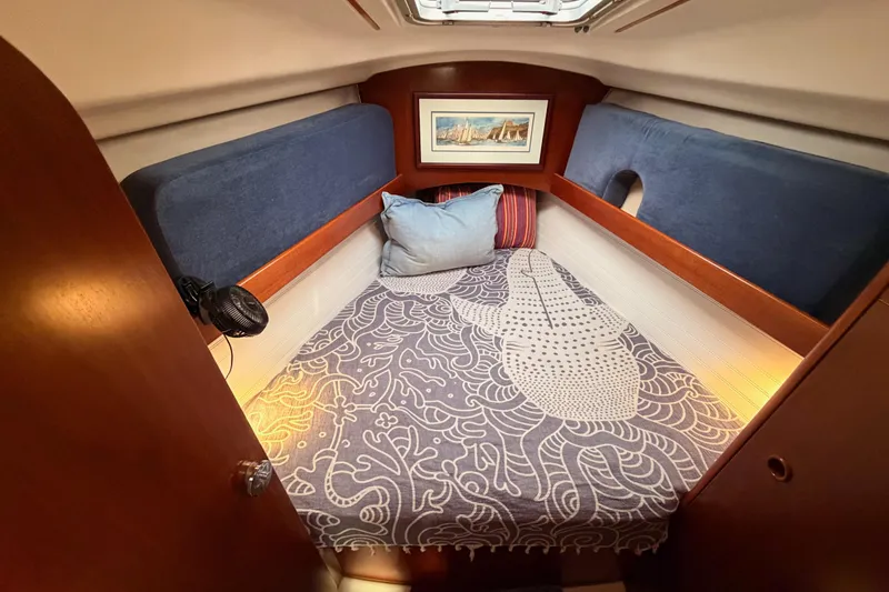 Slide: The Image of Cozy cabin interior of 1997 Beneteau Oceanis 351 sailboat with decorative bedding. - 56