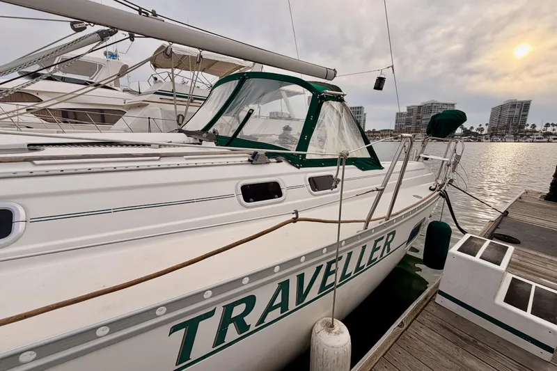 Slide: The Image of 1997 Beneteau Oceanis 351 sailboat docked at marina, sunset in background. - 6