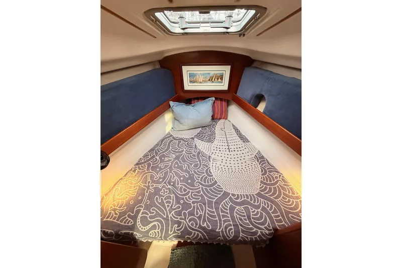 Slide: The Image of Cozy cabin interior of 1997 Beneteau Oceanis 351 sailboat with patterned bedding and artwork. - 60
