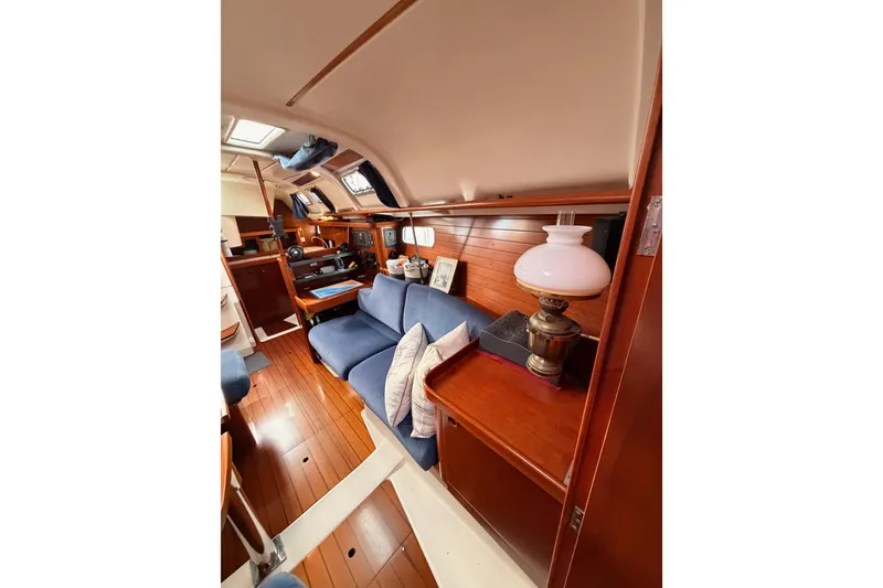 Slide: The Image of Interior of 1997 Beneteau Oceanis 351 sailboat with cozy seating and wooden finishes. - 63