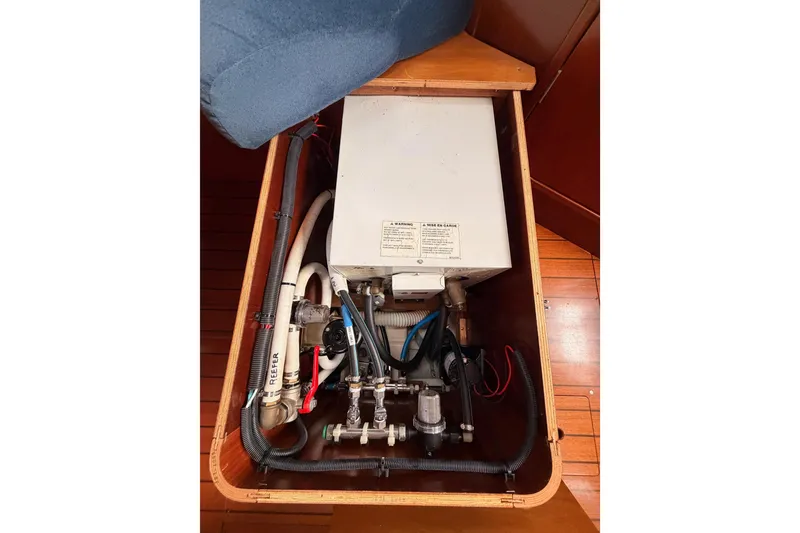 Slide: The Image of 1997 Beneteau Oceanis 351 boat interior showing plumbing and electrical components. - 66