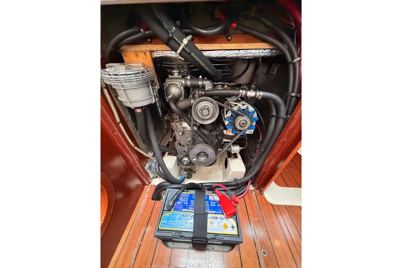 Slide: The Image of Engine compartment of a 1997 Beneteau Oceanis 351 sailboat, featuring visible components and battery. - 68