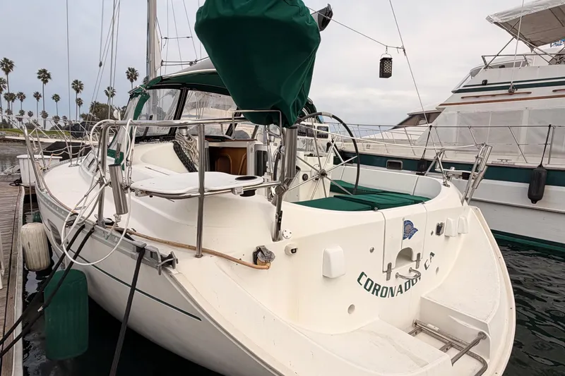 Slide: The Image of 1997 Beneteau Oceanis 351 sailboat docked, featuring green covers and sleek design. - 7