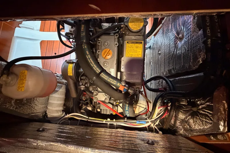 Slide: The Image of Engine compartment of a 1997 Beneteau Oceanis 351 sailboat, showing detailed mechanical components. - 70