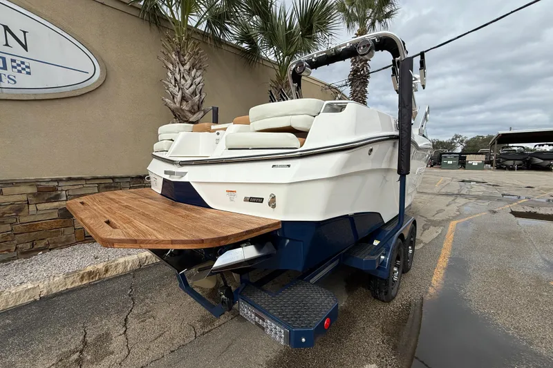 Slide: The Image of 2022 MasterCraft XT24 boat on trailer, rear view with swim platform. - 4
