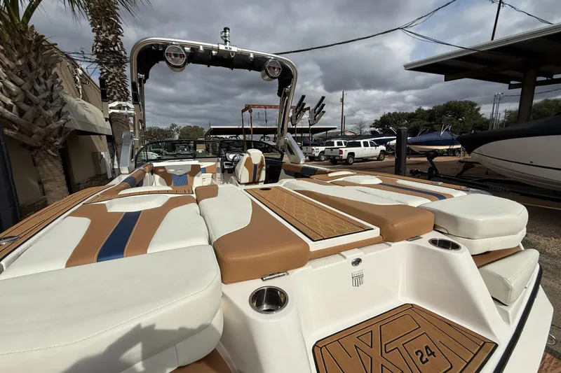 Slide: The Image of 2022 MasterCraft XT24 boat with luxurious seating and sleek design. - 7